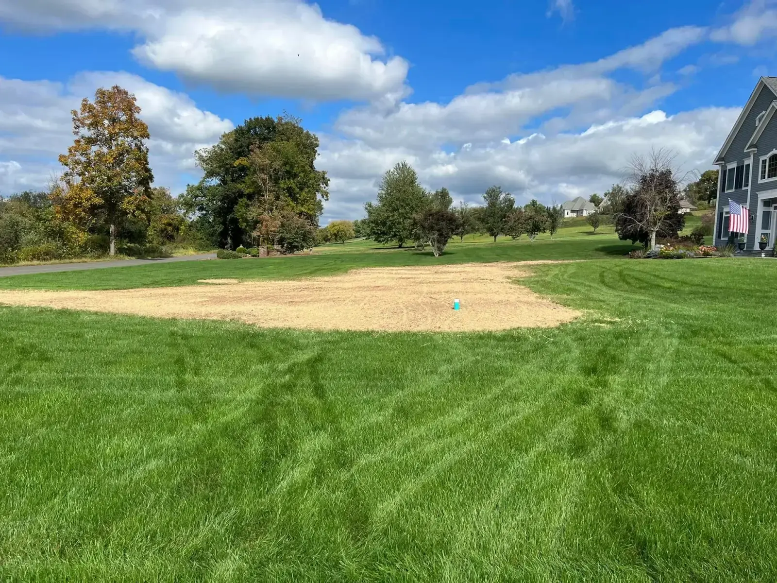 A finished, restored septic field reseeded into a clean green Connecticut lawn after a Summit Septic job